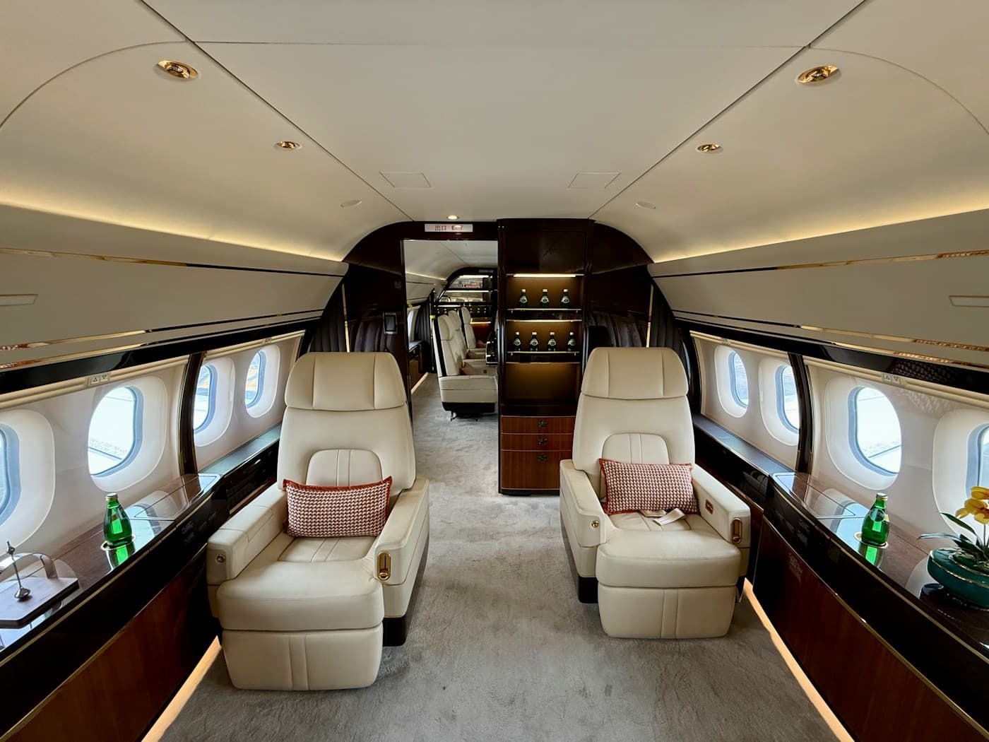Wide cabin with facing cream leather seats and a cabinet
