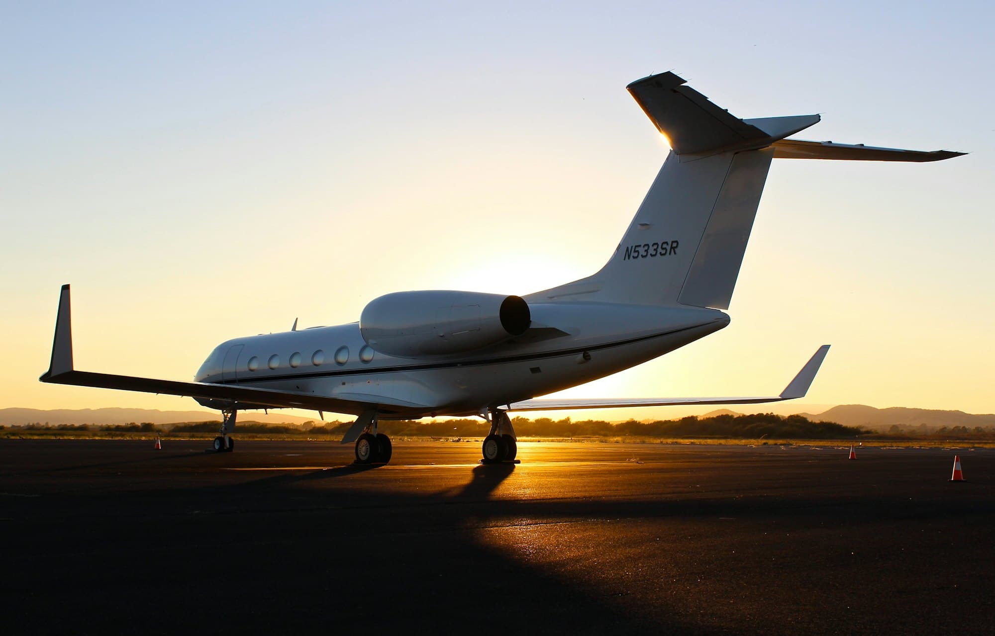 Business jet parked on the apron at sunset